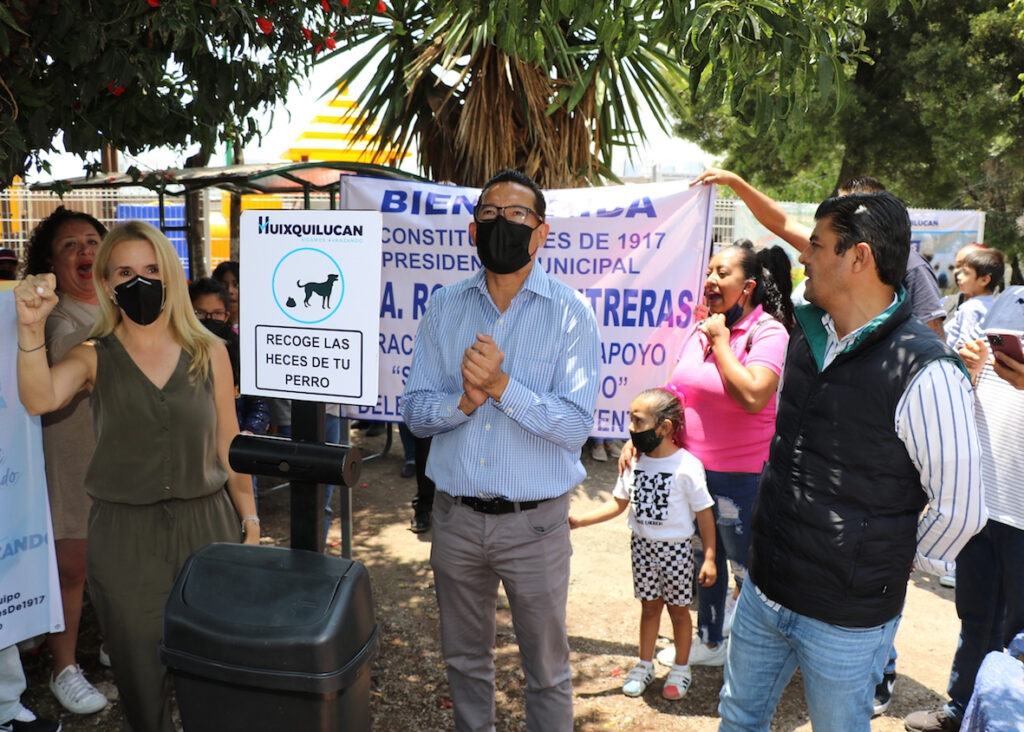 Romina Contreras y colonos en la instalación de contenedores de heces de mascotas